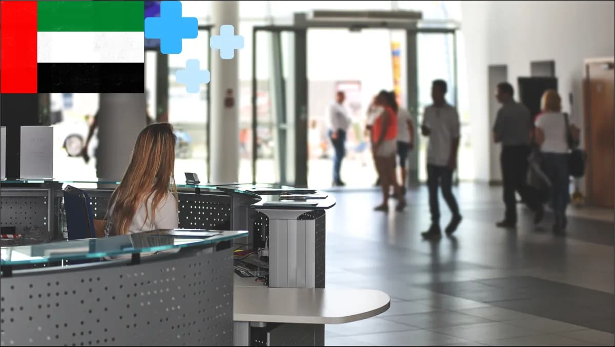 A bilingual EN+AR reception flow at a UAE hospital front desk with infection-control signage, badge printer and emirate-level health-exchange context cards.